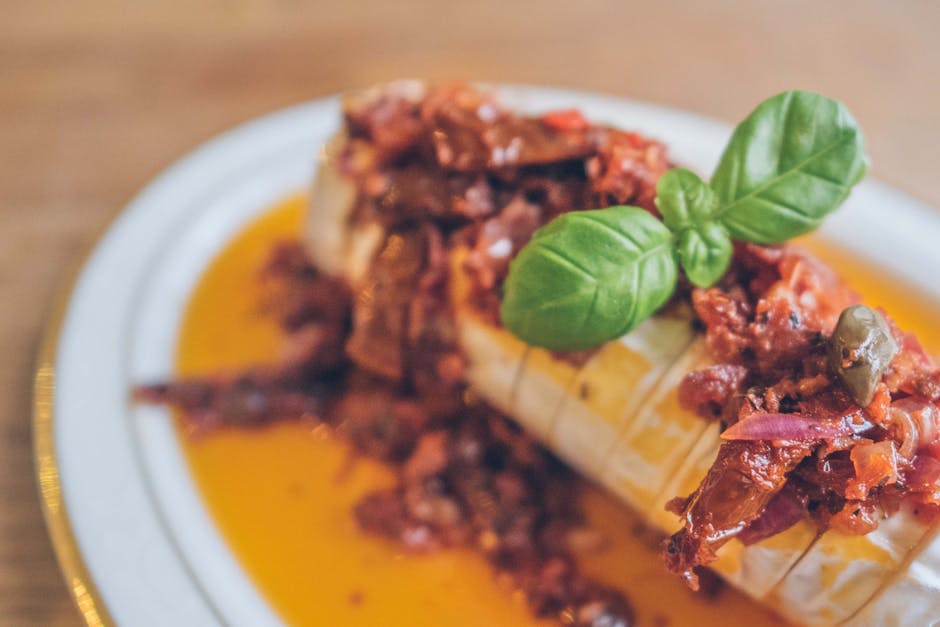 A variety of Indonesian traditional food served on a clean wooden table with a halal certification logo prominently displayed in the background.